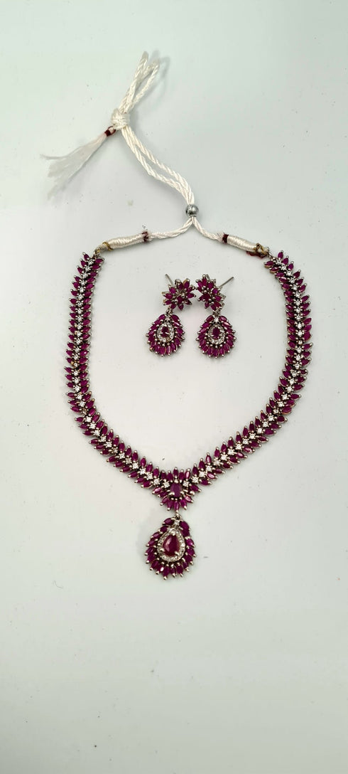 Gold Plated Sleek Necklace Set With Deep Pink Stones.